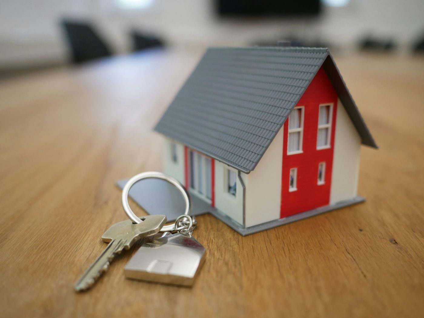 A small model house with a set of house keys